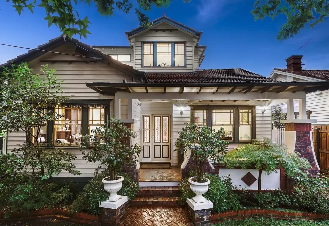 Weatherboard house with an upper-storey gable, front porch and garden